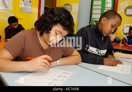 Pupils in creative writing workshop taking place in classroom of a multicultural primary school in UK Stock Photo