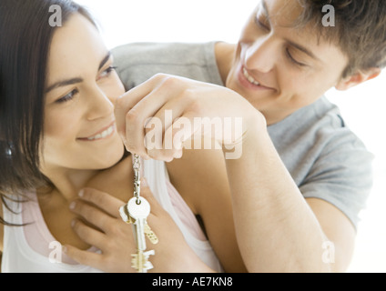 Man handing woman keys Stock Photo