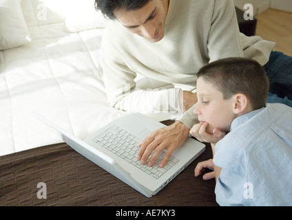 Man and son using laptop Stock Photo