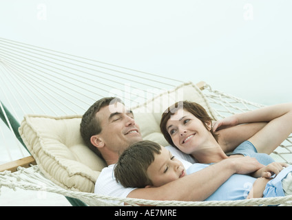 Family relaxing in hammock Stock Photo