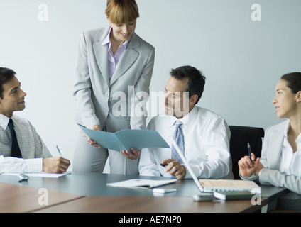 Businesswoman showing file in meeting Stock Photo
