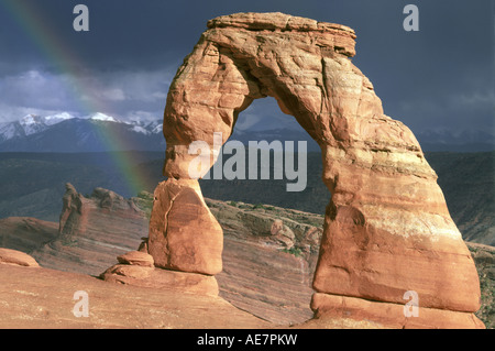 A rainbow after a desert thunderstorm frames Delicate Arch a sandstone arch in the backcountry of Arches National Park, Utah. Stock Photo