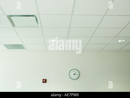 Clock on wall in office space Stock Photo