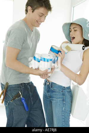 Couple holding painting supplies Stock Photo