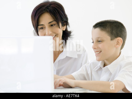 Boy and grandmother using laptop Stock Photo