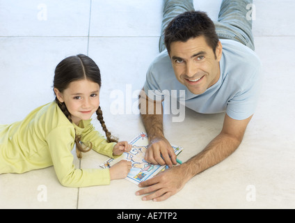 Father and daughter putting together puzzle together Stock Photo