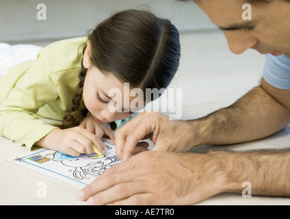 Girl coloring with father Stock Photo