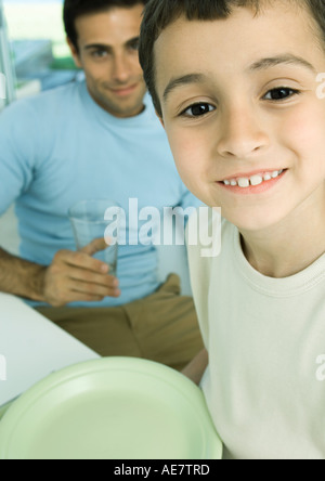 Boy and father with dishes Stock Photo