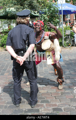 Hamburg Festival cultural Altonale. Black man playing with policeman Stock Photo