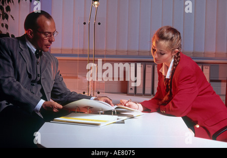 Businessman and businesswoman reading document Stock Photo