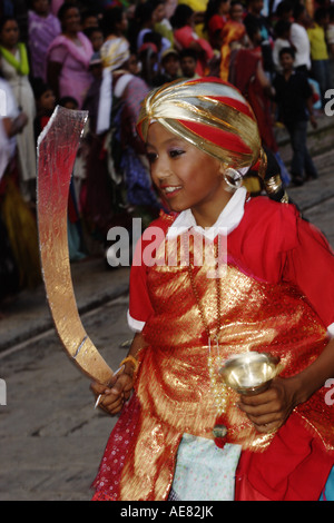 Young performer with sword and cup in his hand during Gai Jatra festival in Kathmandu Nepal Stock Photo