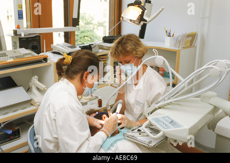 Female dentist with assistant talking on phone in Helsinki Finland Stock Photo