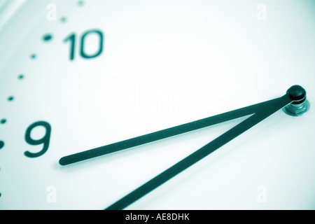 modern clock face showing hands and the numbers ten and nine Stock Photo