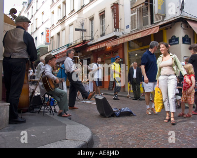 Jazz trio of street musicians play music on corner of Rue Mouffetard 5th Arrondissement left bank Paris France Stock Photo