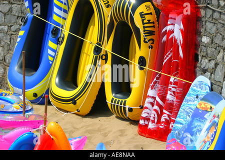 Inflatable boats and sunbeds for sale on the beach at Weston super Mare Stock Photo