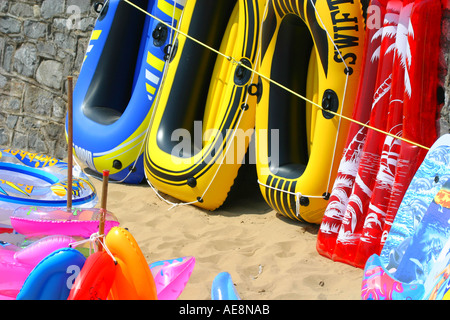 Inflatable boats and sunbeds for sale on the beach at Weston super Mare Stock Photo