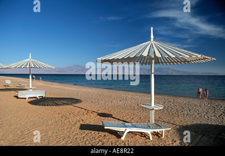 Red Sea coast at Nuweiba Sinai Egypt Arabian Mountains across the straits Beach chair and parasol Vacation photo Middle East Stock Photo