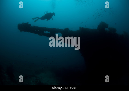 A diver hovers over the bow sprit of a Japanese ship sunk during World War II in Palau. Stock Photo