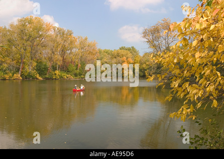 Lake in autumn couple in red canoe Skokie Lagoons Illinois Stock Photo