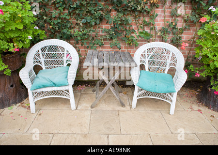 Two White Cane Garden Chairs UK in Summerhouse Stock Photo