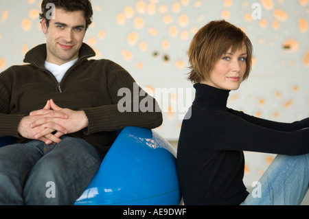 Couple sitting in living-room, looking at the camera Stock Photo