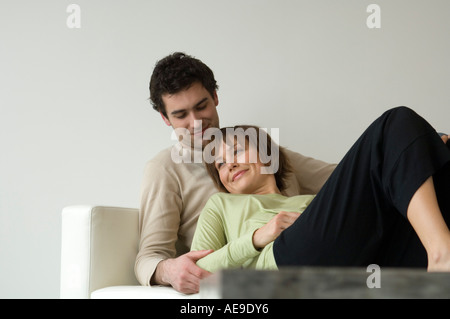 Smiling couple lying on a sofa Stock Photo