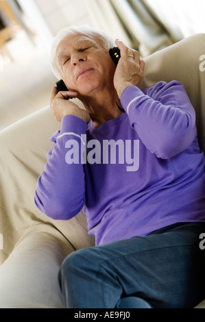 Senior man wearing s, sitting in an armchair Stock Photo