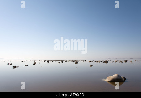 Calm sea at low tide reveals the rocky shallow shoreline at Bothnian Bay , Baltic Sea , Finland Stock Photo
