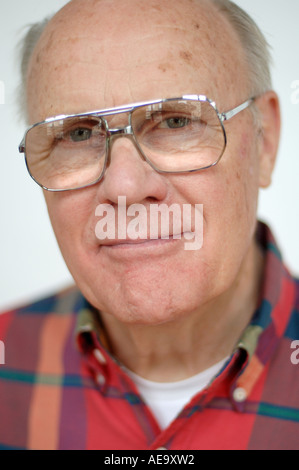 Studio portrait of balding man wearing glasses looking at camera Stock Photo