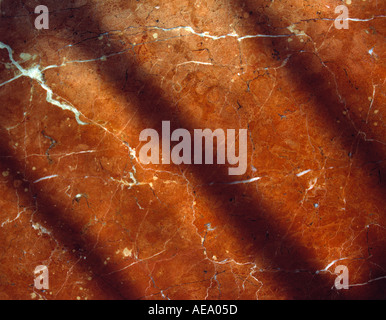 Red marble with diagonal shadows Stock Photo