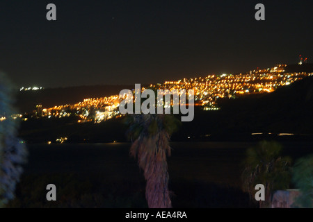 The Sea of Galilee with Tiberias in the background at night Stock Photo