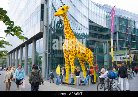 large figure TOY Giraffe made of lego brick ahead of SONY CENTER BERLIN people looking