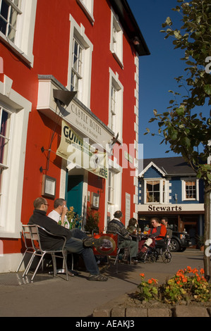 people sitting in the sunshine outside the Castle hotel pub Aberaeron Ceredigion Wales Stock Photo