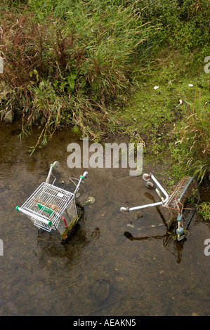 two abandoned shopping trollies discarded in the river, UK Stock Photo