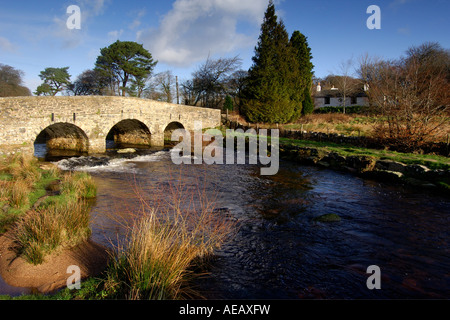 Village of Postbridge Dartmoor showing newer stone road bridge crossing East Dart river flowing beneath Stock Photo