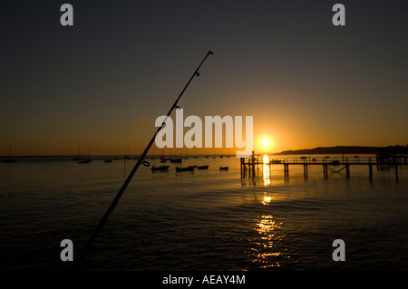 Fishing at dawn for bass and mackerel off the pier at Yamouth Isle of Wight Stock Photo
