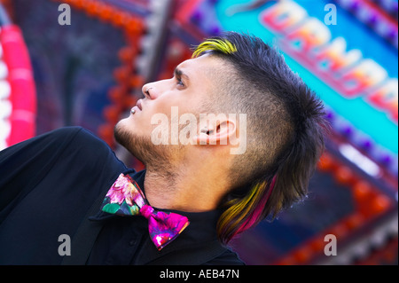 Low angle view of young Hispanic male punk with mohawk and bowtie Stock Photo