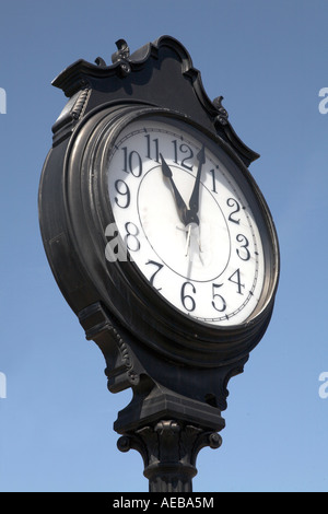 Black Outdoor commuter Clock and sky Stock Photo