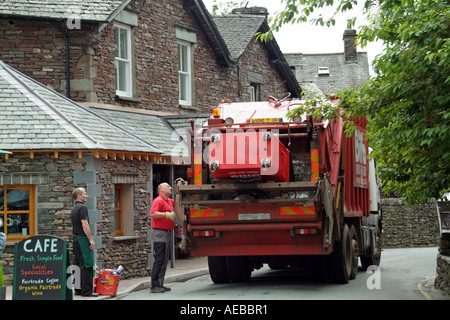 Operatives emptying large refuse bin into refuse collection lorry of the BIFFA company Stock Photo