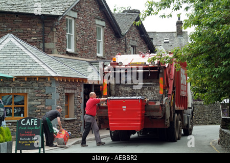 Operatives emptying large refuse bin into refuse collection lorry Stock Photo