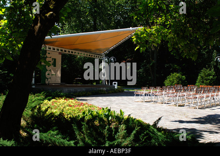 empty stage ready for a performance located in a green bright park Stock Photo