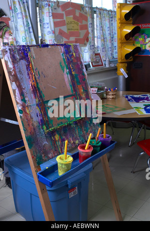 Art Easel With Paint Children’s Kindergarten Class Room, Philadelphia, Pennsylvania PA USA Stock Photo