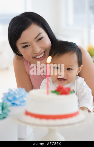 Asian mother celebrating baby's first birthday Stock Photo