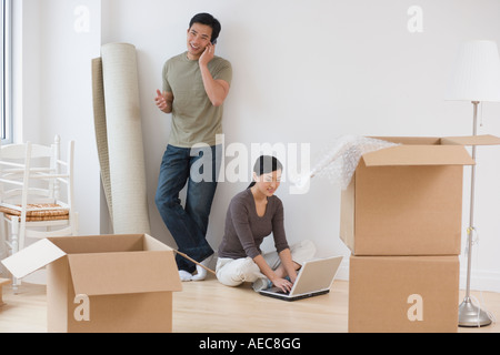 Asian couple taking break from moving Stock Photo