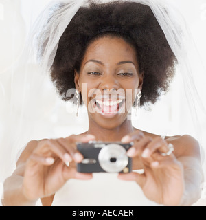 African bride taking photograph Stock Photo