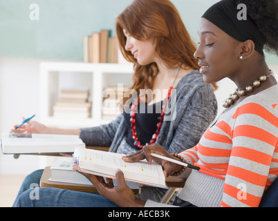 Two female college students studying in class Stock Photo