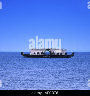 A houseboat , Kettuvallam, sailing through the backwaters of Kerala with background of deep blue sky and water Stock Photo