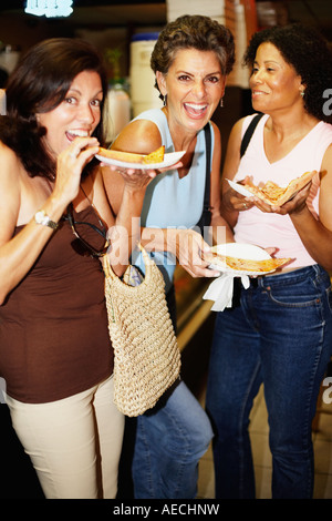 Hispanic women eating pizza Stock Photo