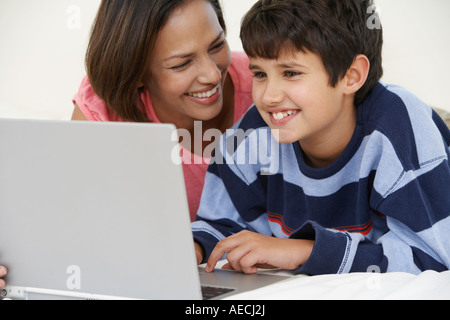 Indian mother and son using laptop Stock Photo