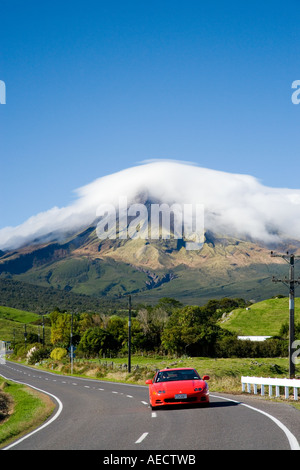 Red Sports Car Road and Mt Taranaki Egmont Taranaki North Island New Zealand Stock Photo